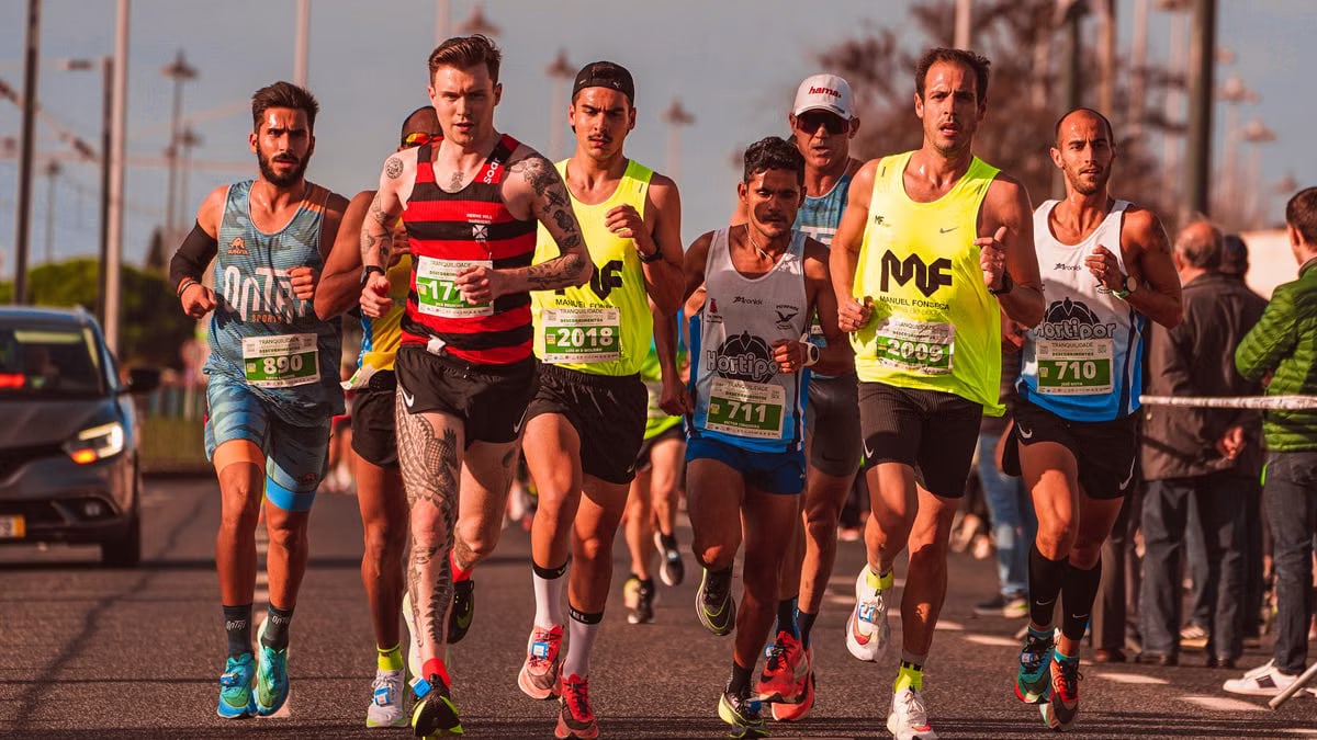 A diverse group of male runners competing in an outdoor marathon race, showcasing athletic endurance and team spirit.